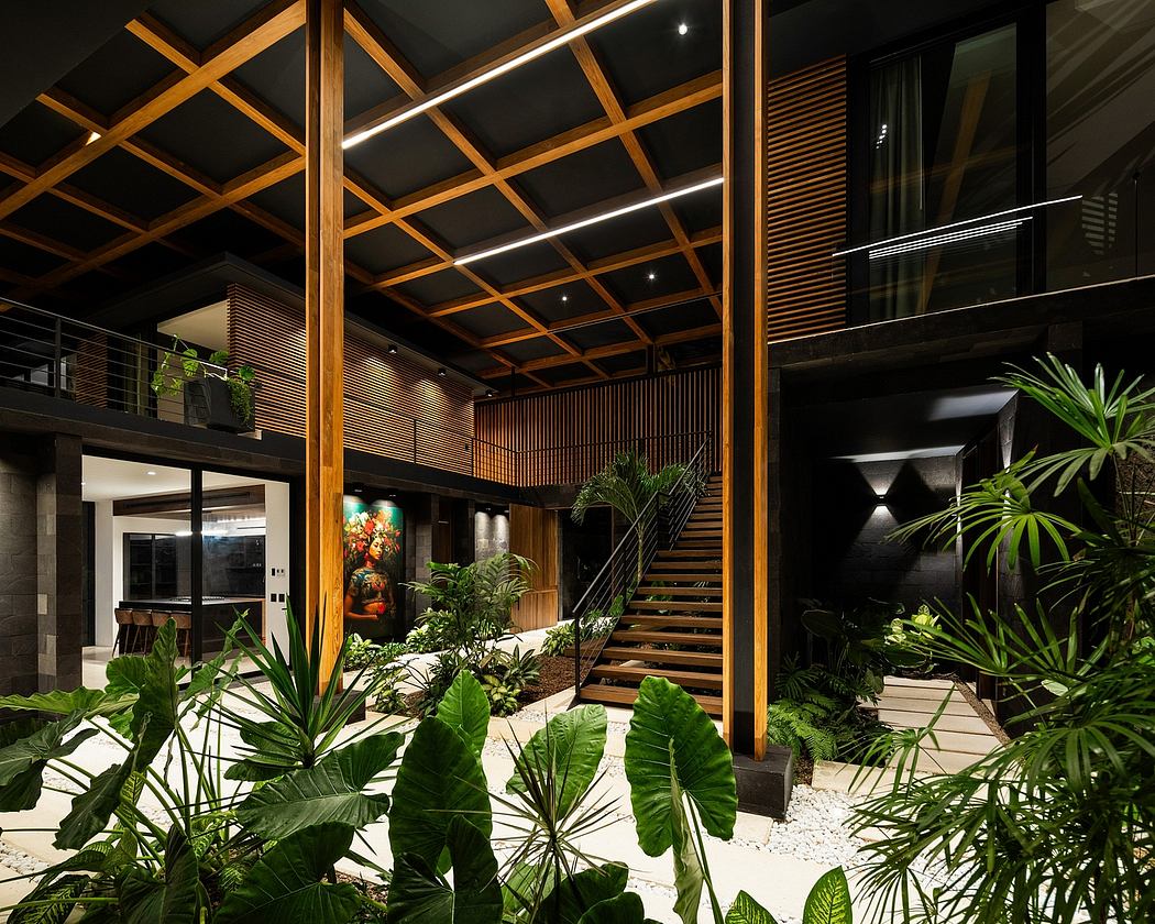 Striking modern interior with lush tropical foliage, wooden beams, and sculptural stairs.