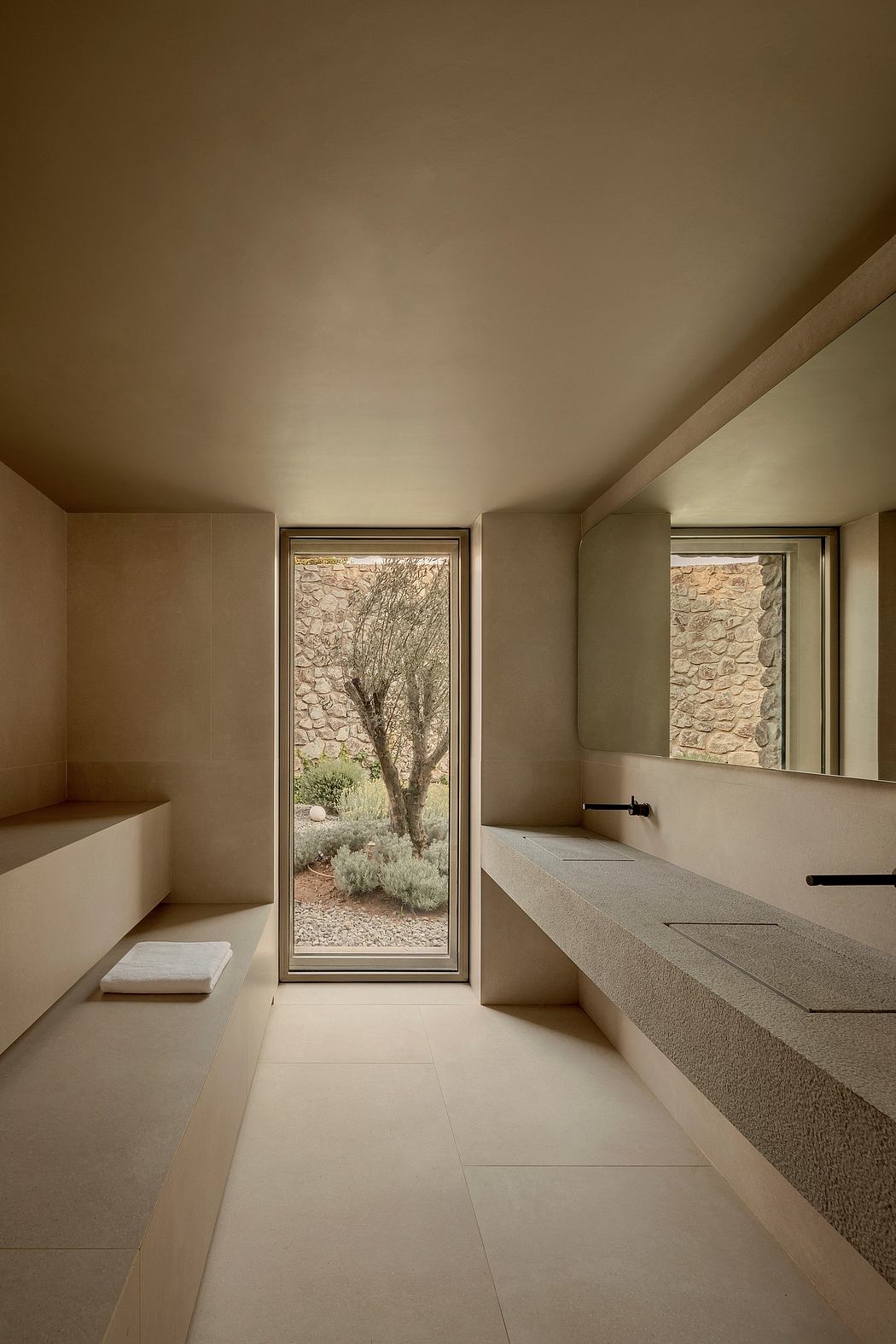 A serene bathroom space with large windows offering a tranquil natural view.