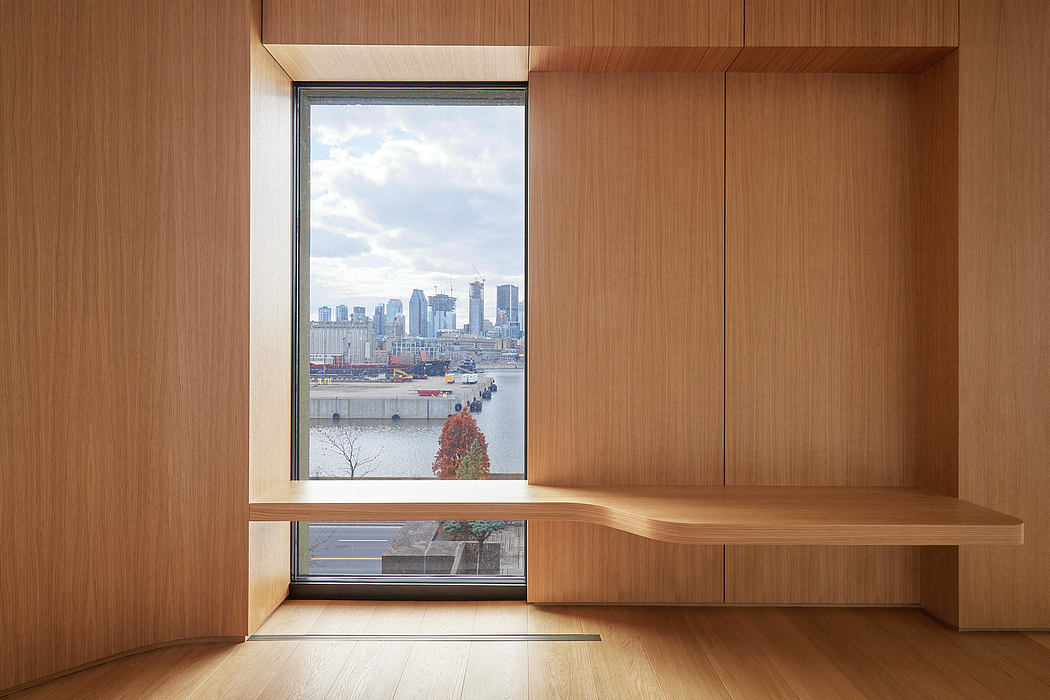 A modern, wooden-paneled room with a large window overlooking a cityscape.