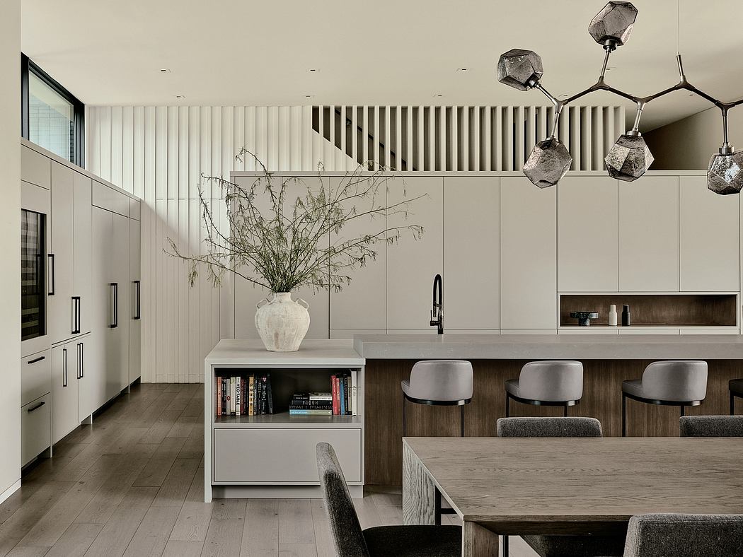 Minimalist kitchen interior with geometric lighting fixtures and built-in shelving.