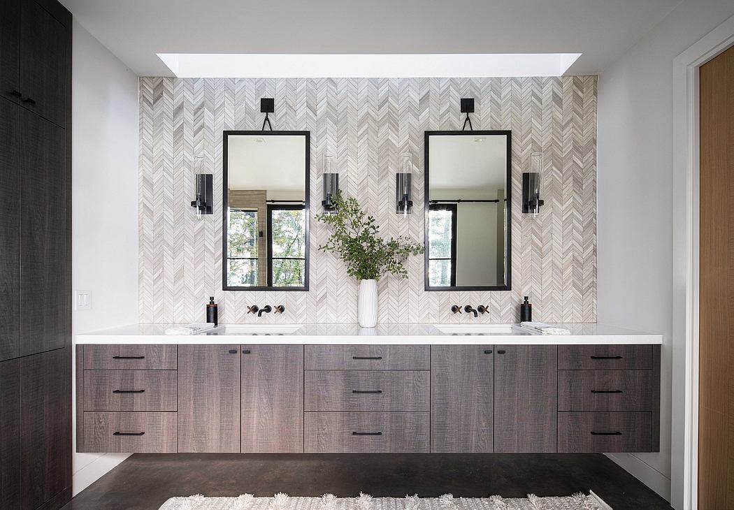 Sleek vanity with mosaic tile backsplash and two modern black framed mirrors.