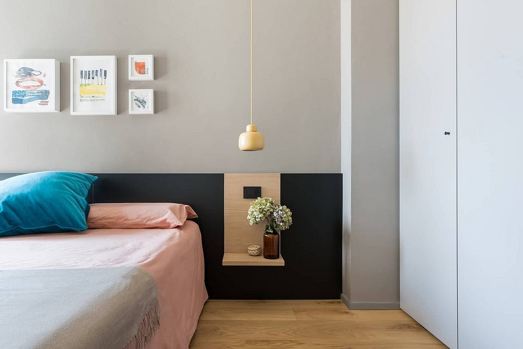 Cozy bedroom with a stylish black and wood headboard, pendant light, and framed art.