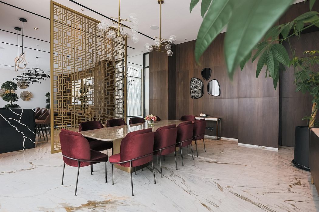 Luxurious dining area with ornate gold screen, marble floors, and plush burgundy chairs.