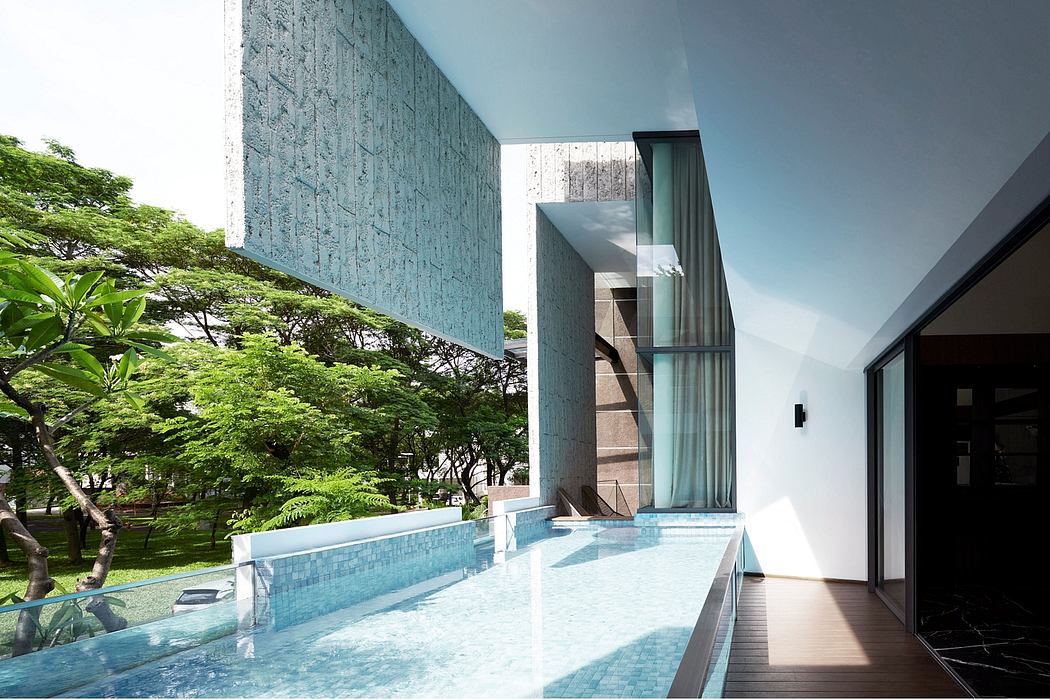 Modern architectural design with minimalist pool, glass walls, and lush greenery.