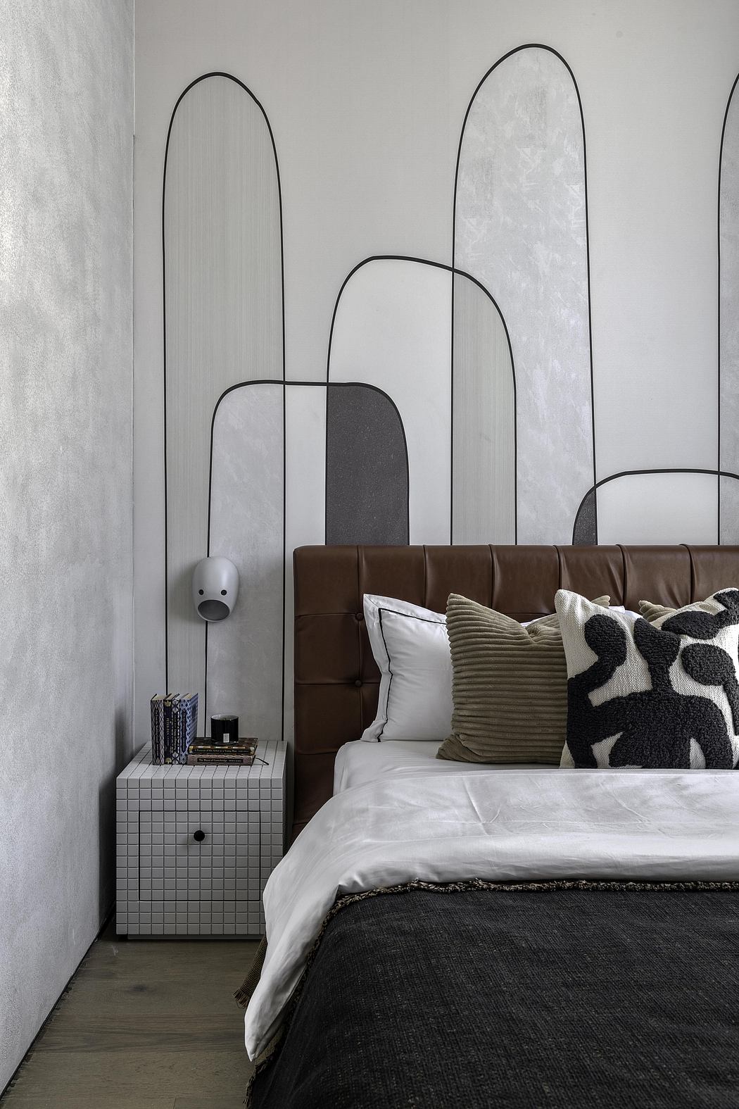 Minimalist bedroom design with abstract geometric wall frames and textured bedding.