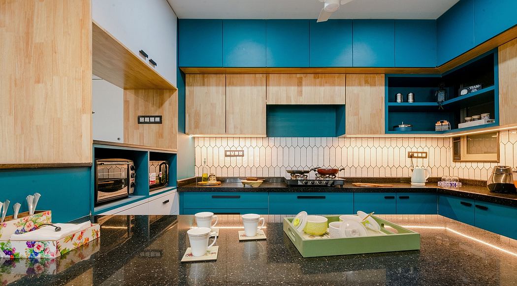 A modern kitchen with vibrant turquoise cabinetry, wood accents, and a patterned backsplash.