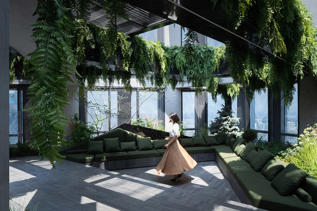 Lush, verdant indoor garden with minimalist seating and large windows overlooking the city.