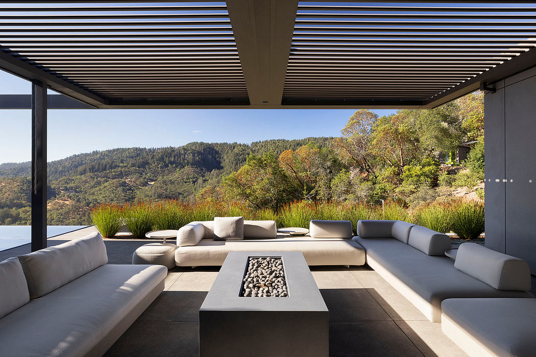 Spacious outdoor lounge area with modern architectural features and scenic mountain view.