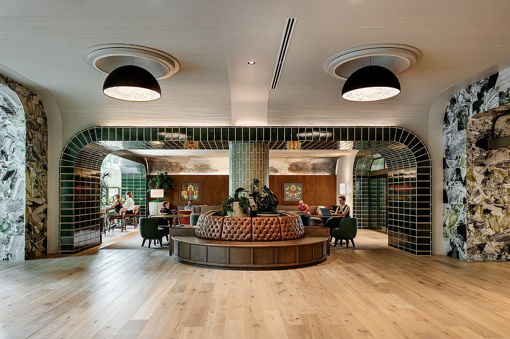 Elegant lobby with arched tile accents, circular leather sofa, and wood flooring.