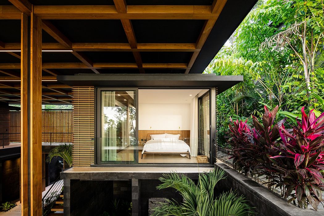 A tranquil, open-air bedroom surrounded by lush tropical greenery and thoughtful design.
