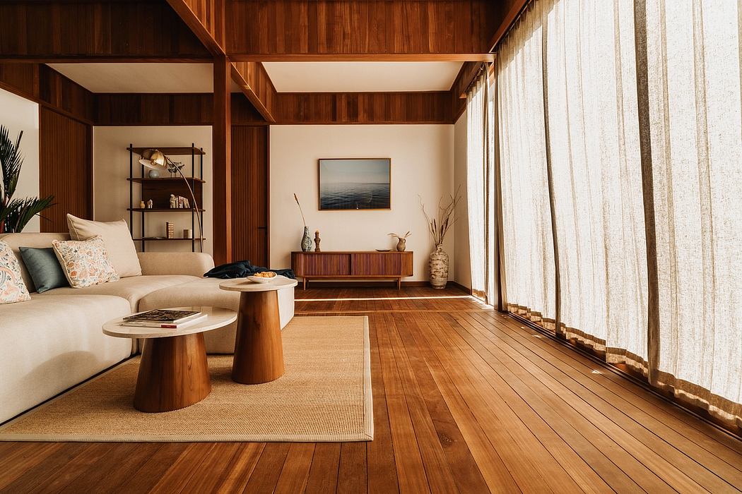 Bright, modern cabin interior with wood paneling, large windows, and stylish furnishings.