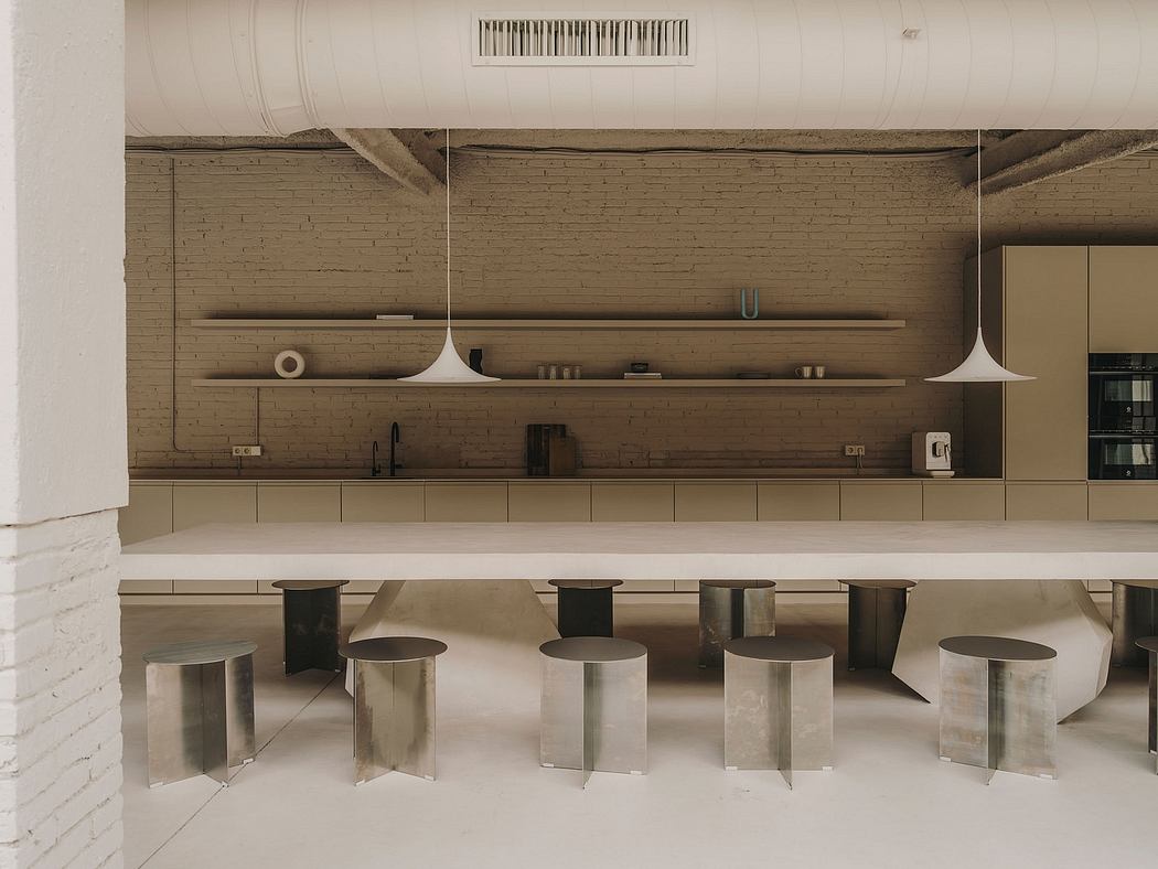 Minimalist industrial kitchen with brick walls, floating shelves, and metal stools.