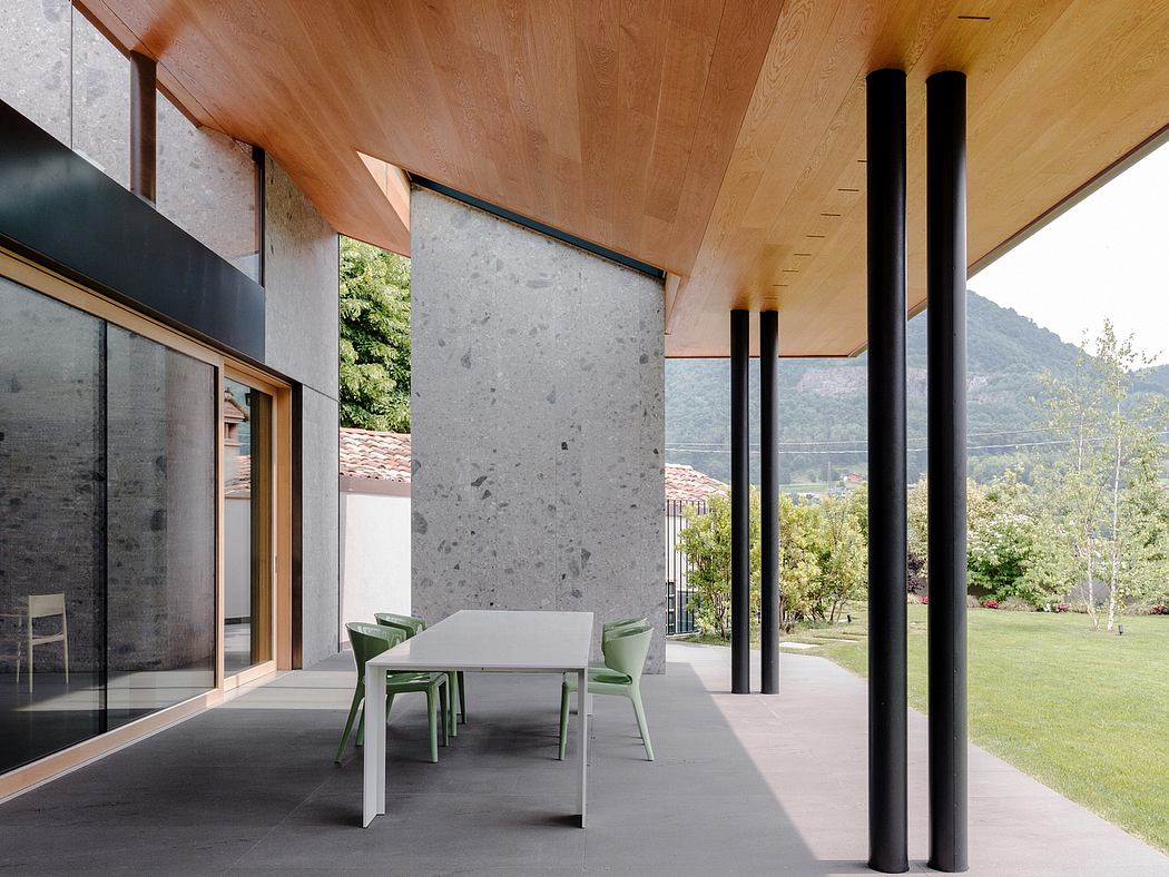 Sleek, modern outdoor space with concrete, wood, and glass design elements.