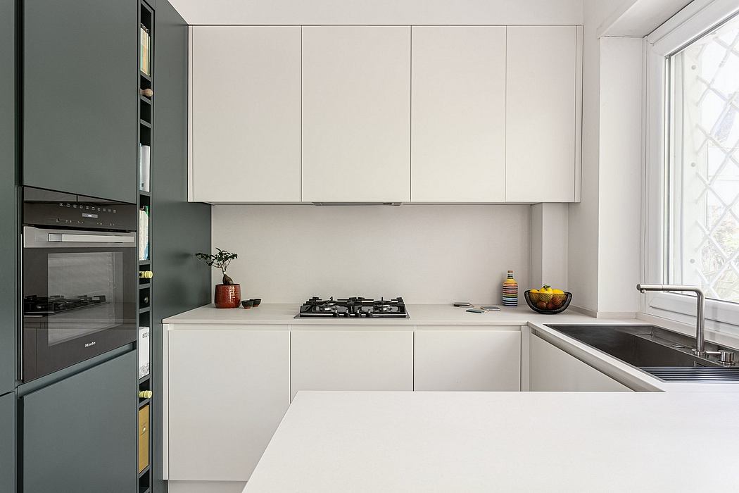 Modern, minimalist kitchen with sleek white cabinetry, integrated appliances, and neutral tones.