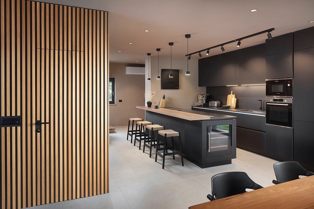 Contemporary kitchen with sleek black cabinetry, wooden accents, and pendant lighting.