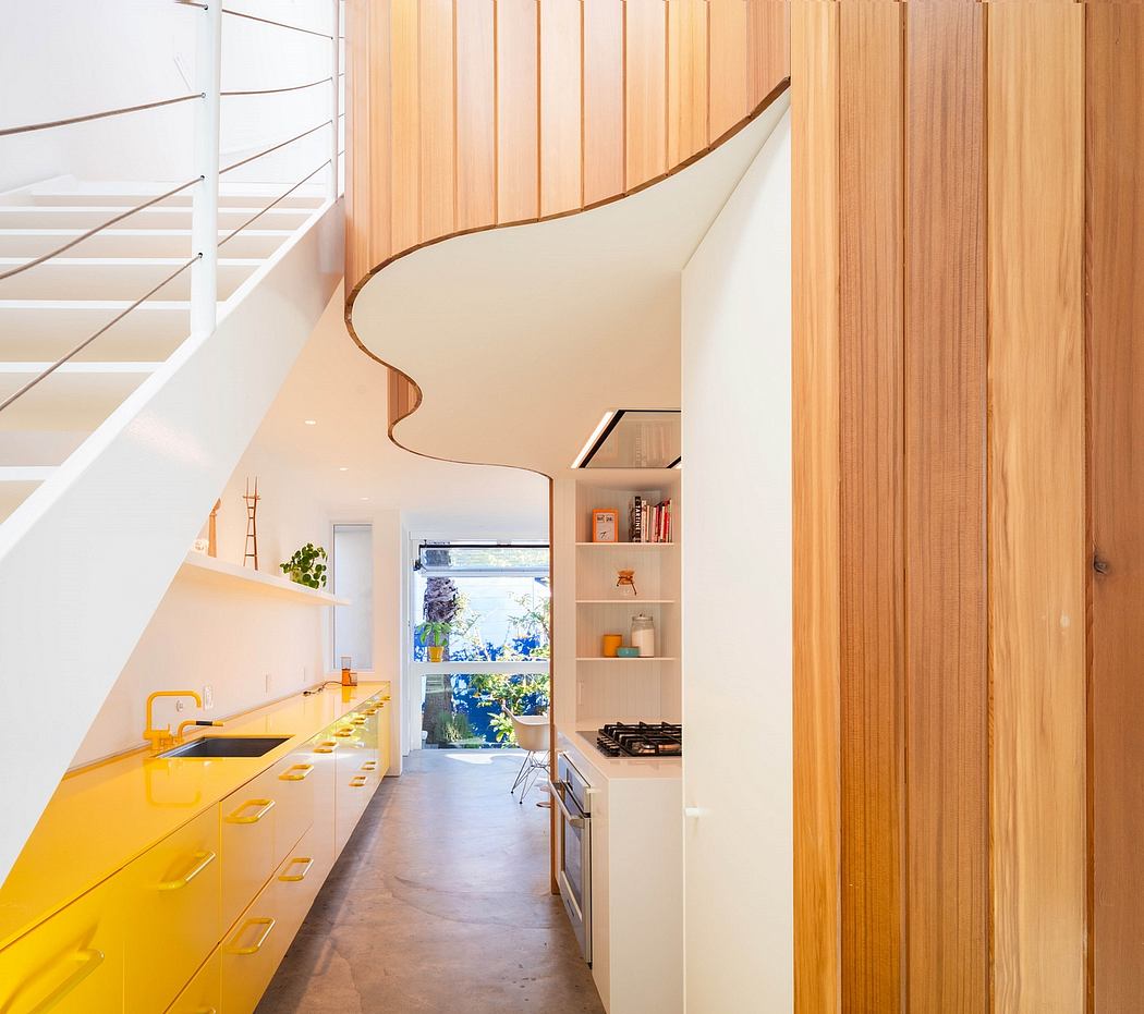 Bright, modern kitchen with curved wooden walls and yellow cabinet details.