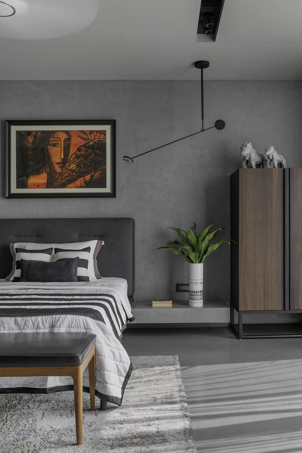 Sleek modern bedroom with striking artwork, minimalist furniture, and mood lighting.