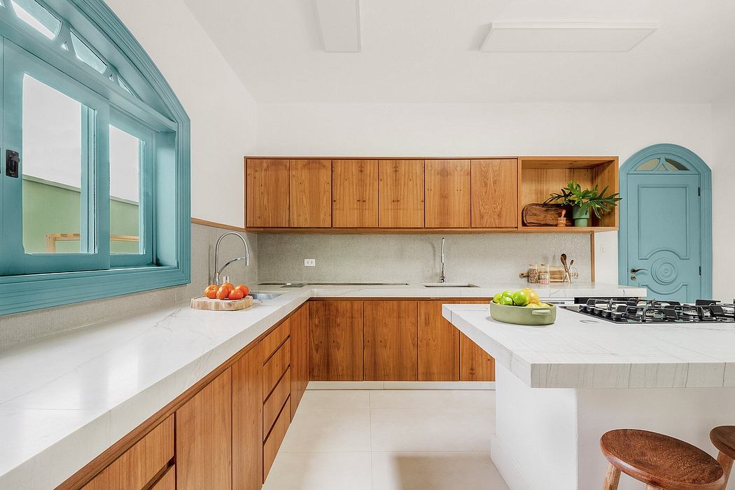 Bright, airy kitchen with wooden cabinetry, white countertops, and a large window.