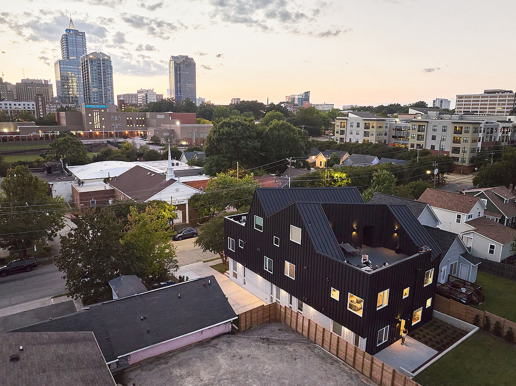 Modern urban architecture with rooftop features, brick buildings, and city skyline.