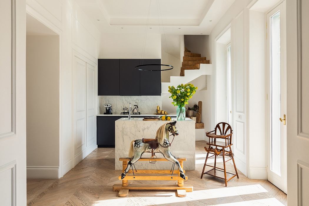 Bright, open-concept kitchen with minimalist black cabinetry, marble island, and eclectic decor.