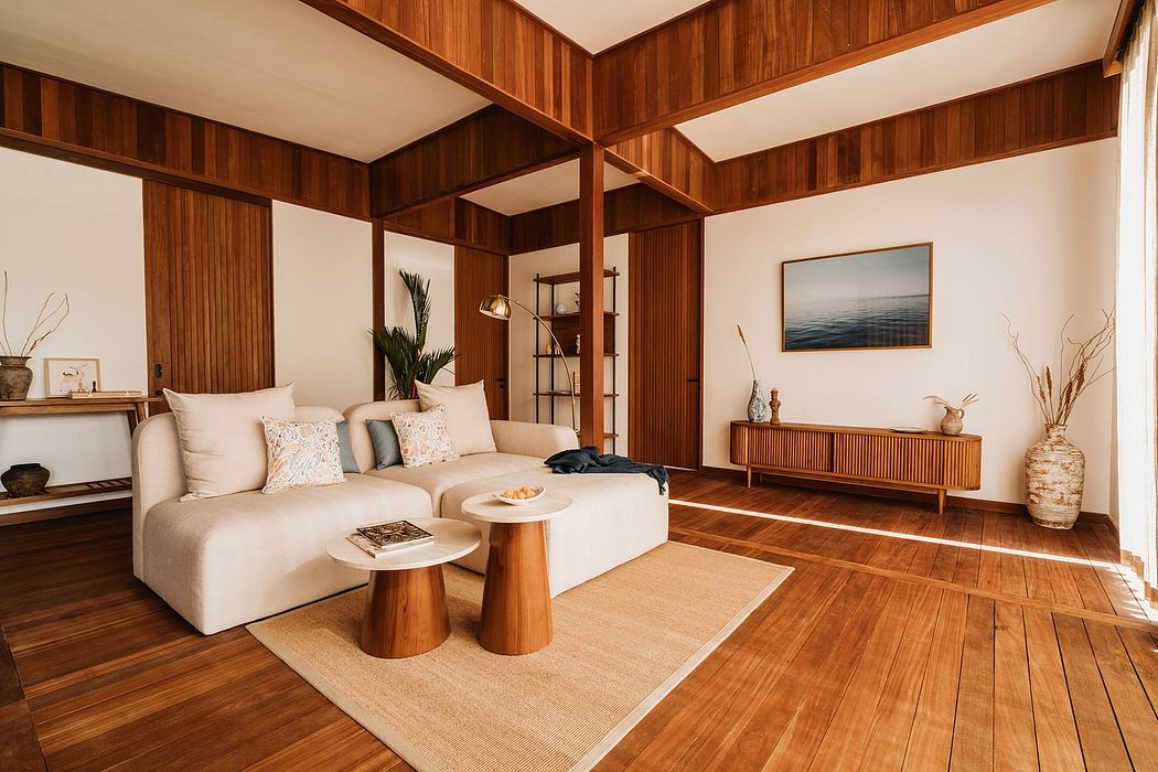 Modern, cozy living room with warm wood paneling, plush seating, and minimalist decor.