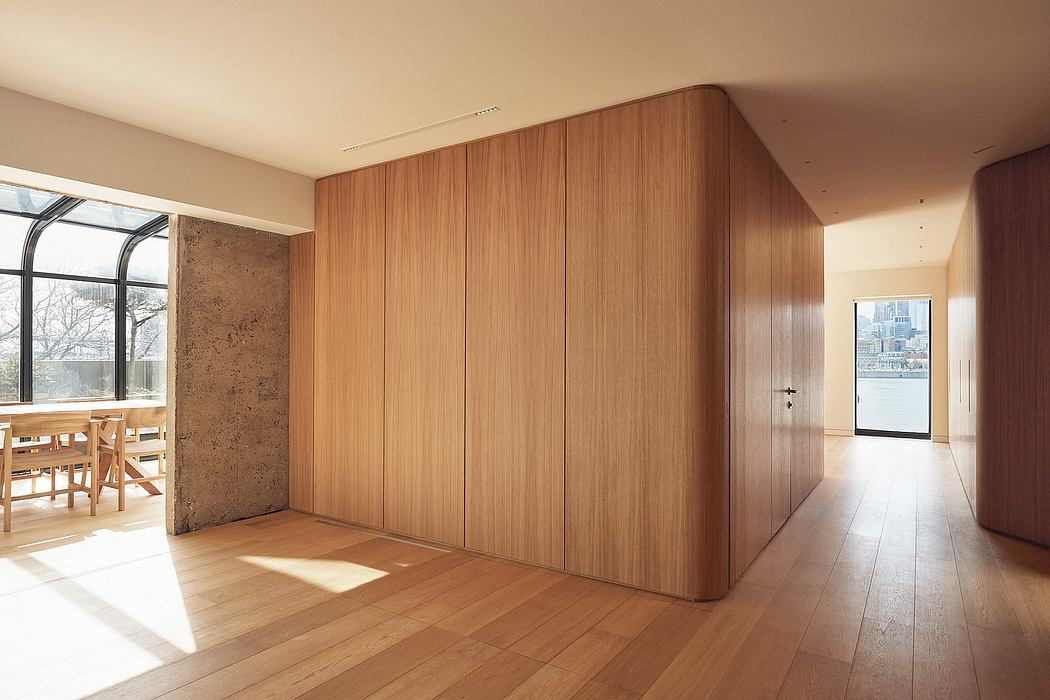 Spacious open-concept interior with warm wood paneling and natural lighting.