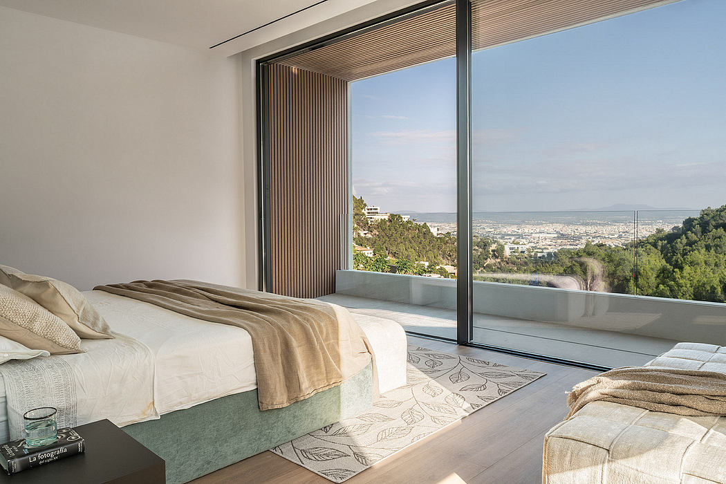 Spacious modern bedroom with floor-to-ceiling windows offering panoramic city views.