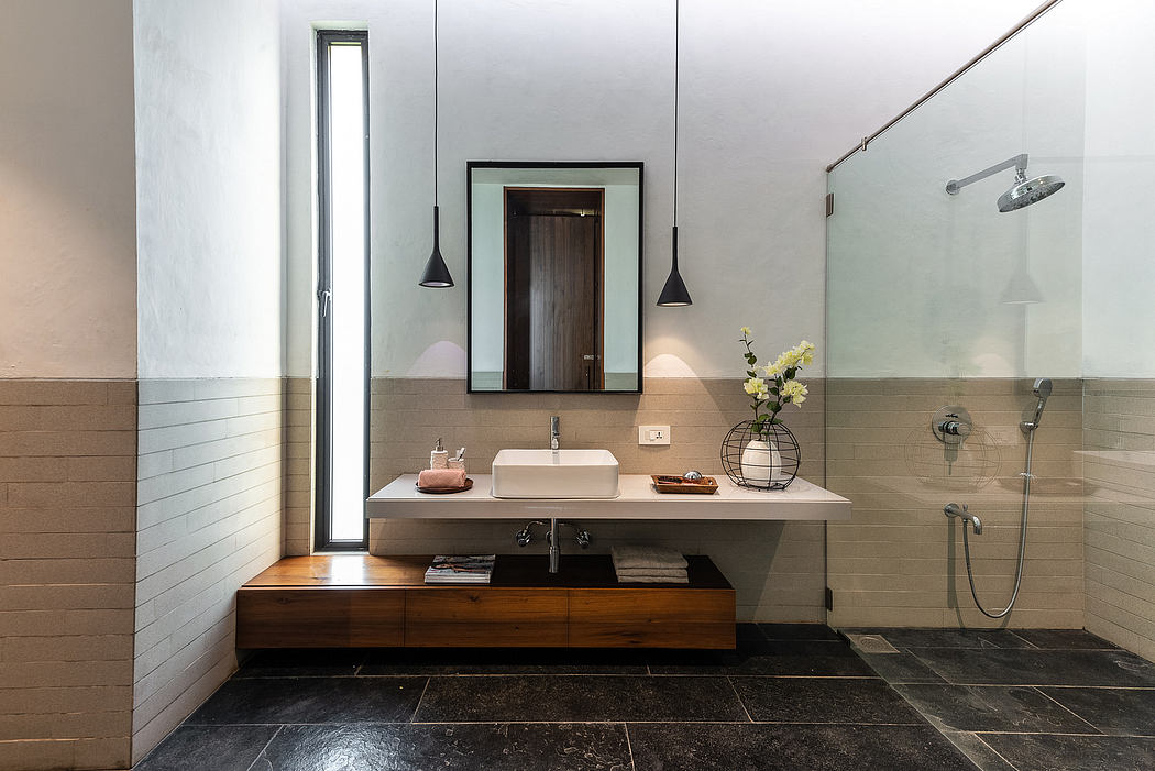 Sleek, modern bathroom with minimalist vanity, wall-mounted mirror, and recessed lighting.