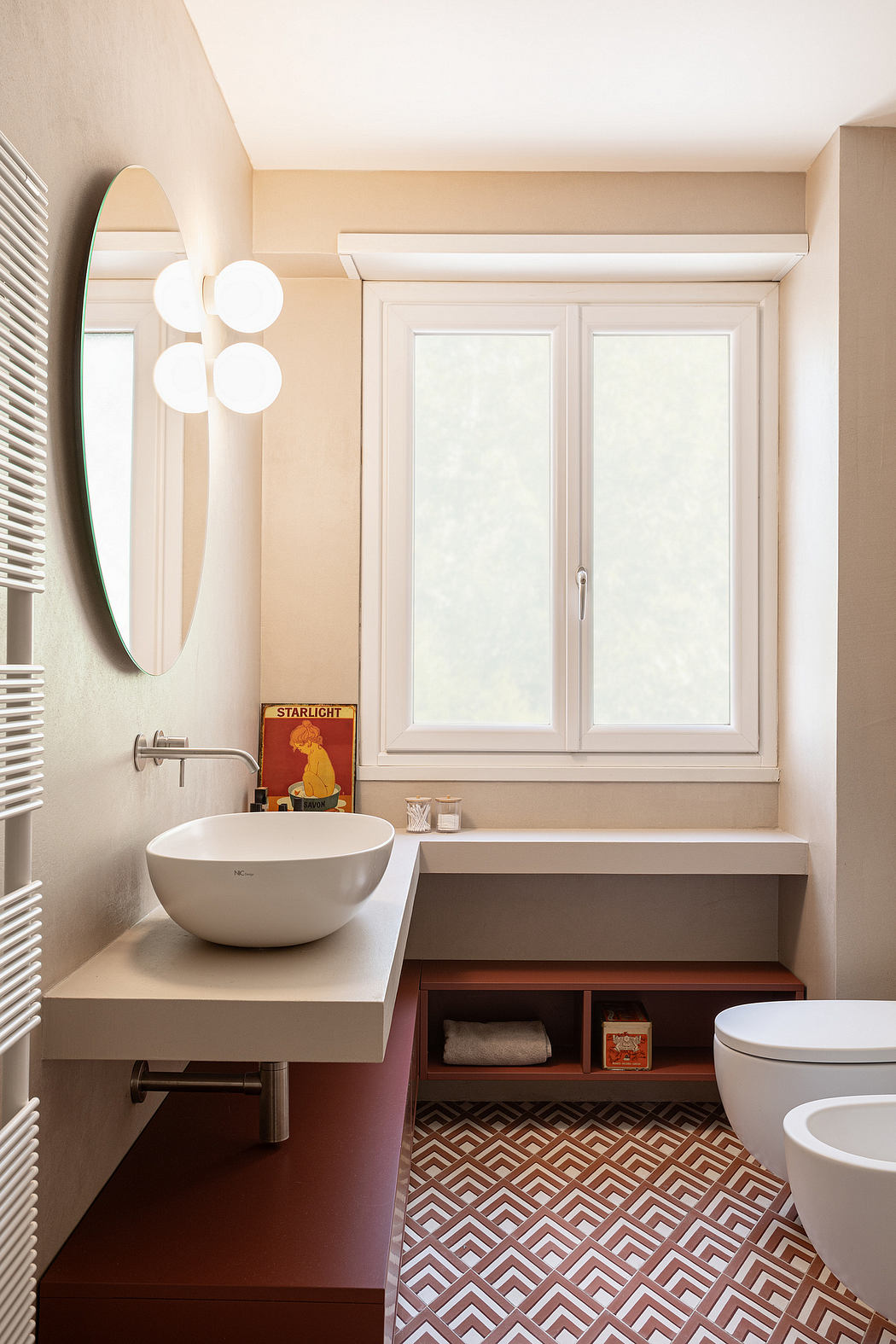 Well-designed modern bathroom with sleek vanity, patterned floor tiles, and wall-mounted mirror.