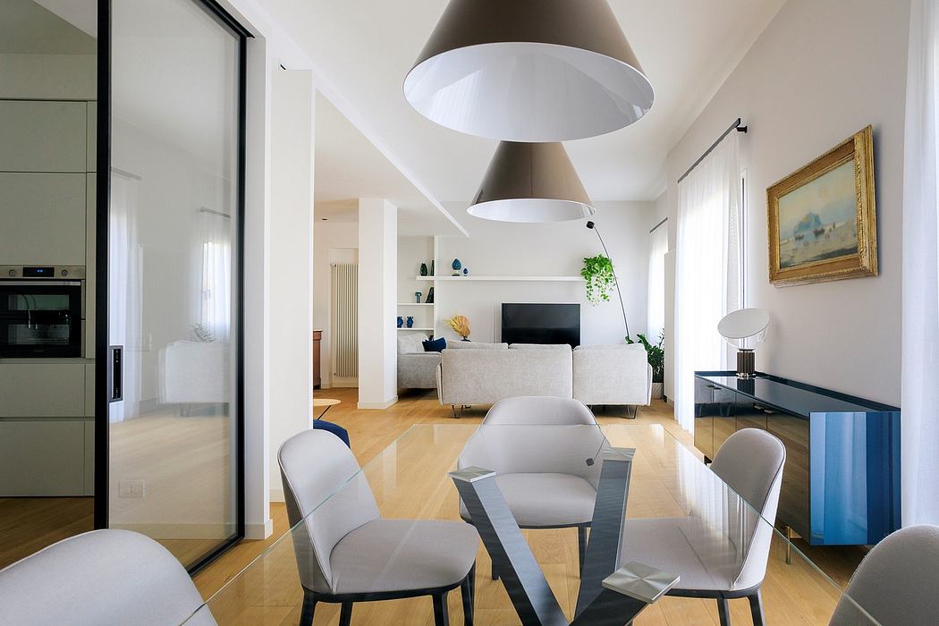 Minimalist interior with sleek furniture, pendant lights, and hardwood floors.