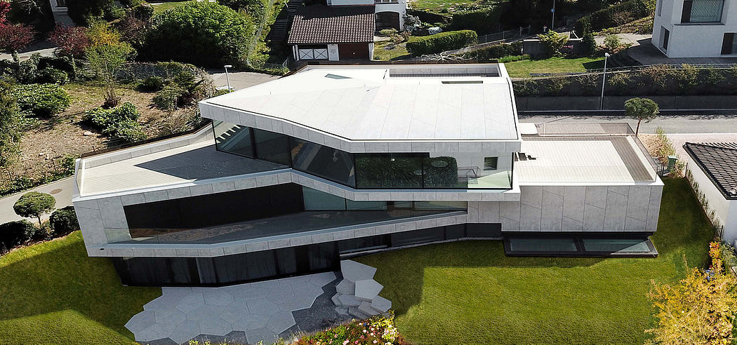 A contemporary, geometric architectural design with a tiered, angular facade and expansive windows.