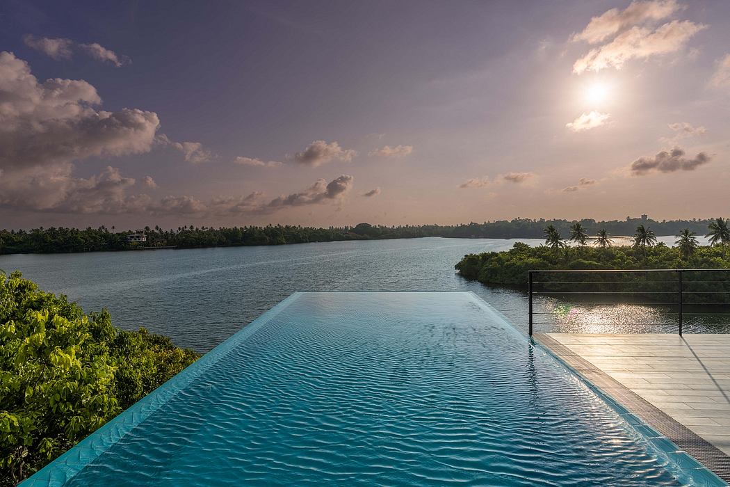 Stunning infinity pool overlooking lush island landscape and serene lake at sunset.