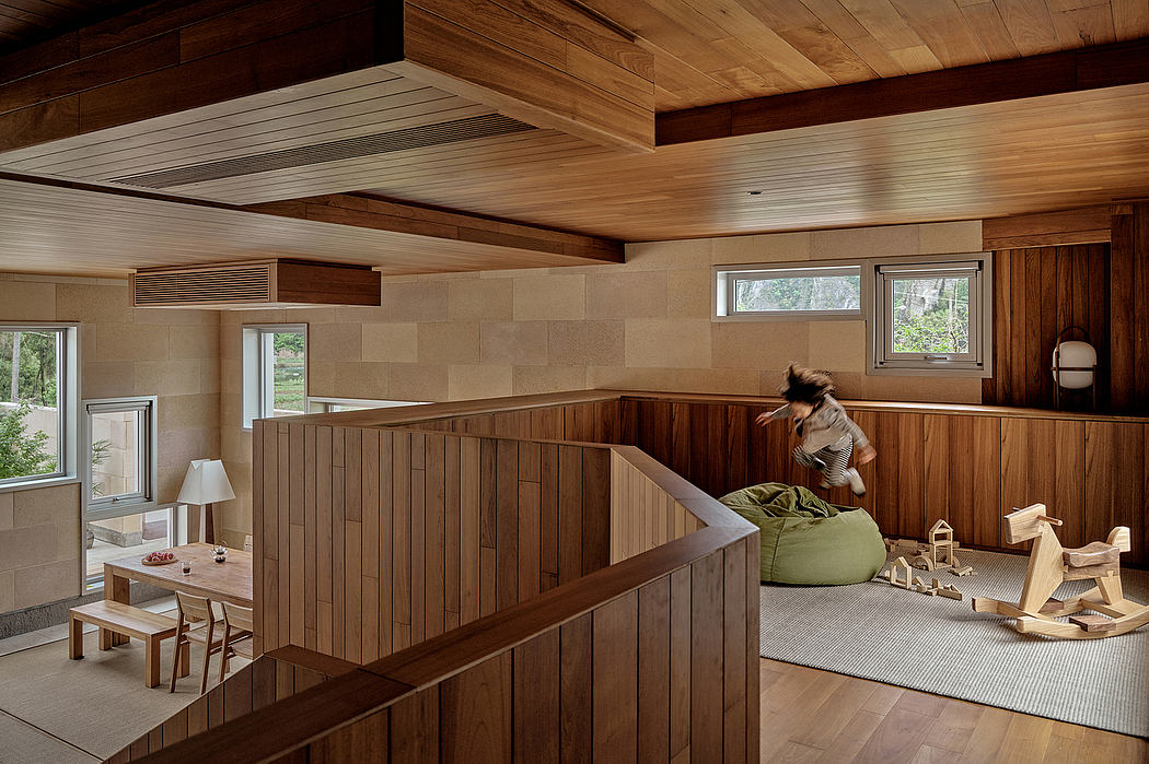 A cozy, wooden-paneled interior with a raised seating area, modern furniture, and natural lighting.