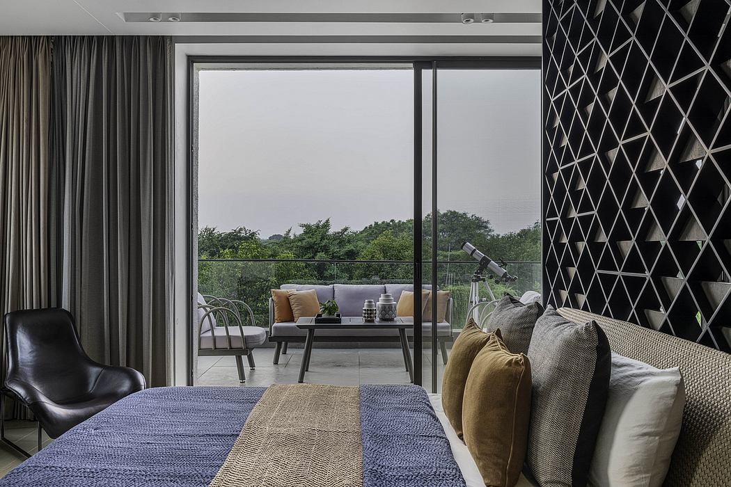Luxurious bedroom with floor-to-ceiling windows, stylish furniture, and geometric wall patterns.