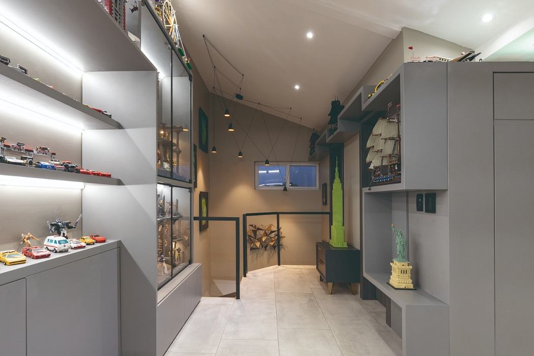 Sleek, contemporary interior with geometric shelving, lighting, and neutral tones.