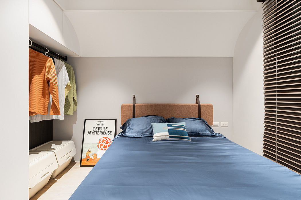 A minimalist bedroom with a sleek, modern design featuring neutral colors, clean lines, and a frameless artwork.