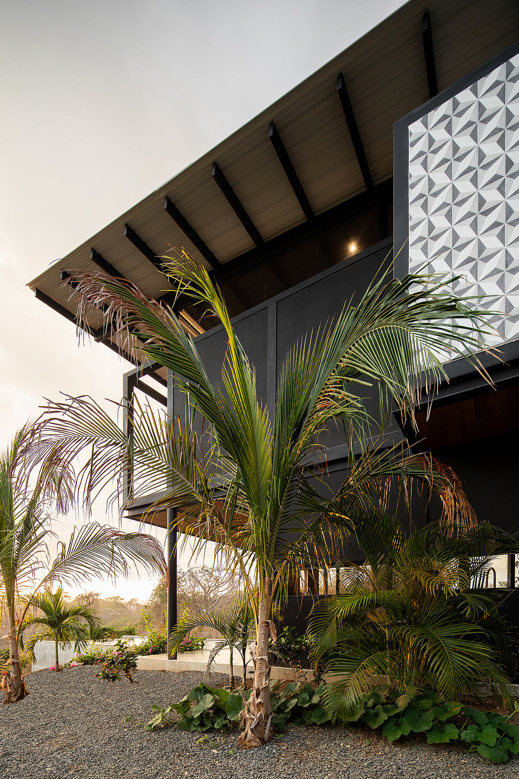 Tropical architectural elements including geometric patterns, palm trees, and natural landscaping.