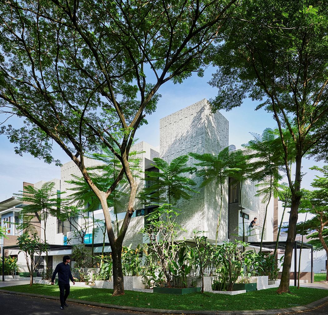 Striking modern architecture framed by lush greenery and walkways in an urban setting.