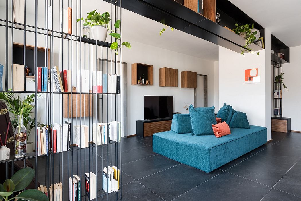 Modern living room with sleek metal shelving, wooden storage, and a teal sofa.
