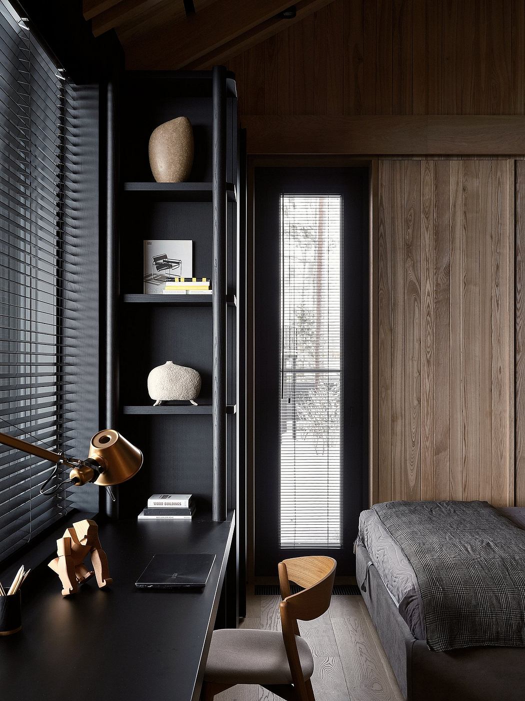 Sleek, modern bedroom design with black built-in shelving, wood paneling, and minimalist decor.
