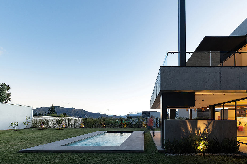 A modern, minimalist home with a sleek exterior, an inviting pool, and lush landscaping.