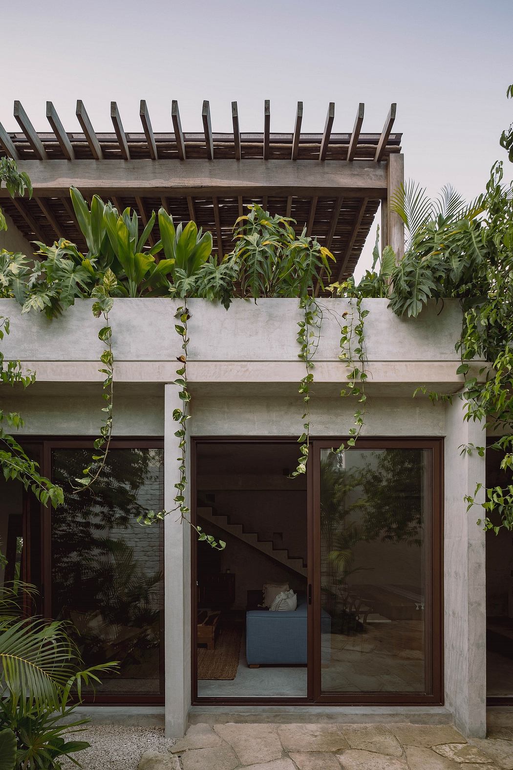 A modern tropical home with a breezy, open-plan design and lush, green landscaping.