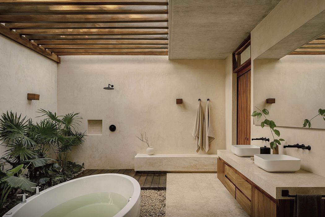 An airy, modern bathroom with a wooden ceiling, stone countertops, and lush foliage.
