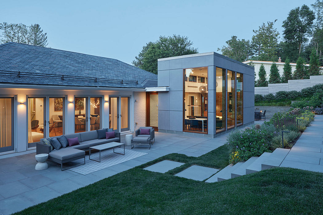 Modern two-story home with sleek exterior, expansive patio, and well-manicured landscaping.