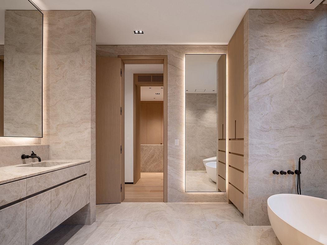 Elegant, minimalist bathroom with natural stone walls and wood accents, highlighting modern design.