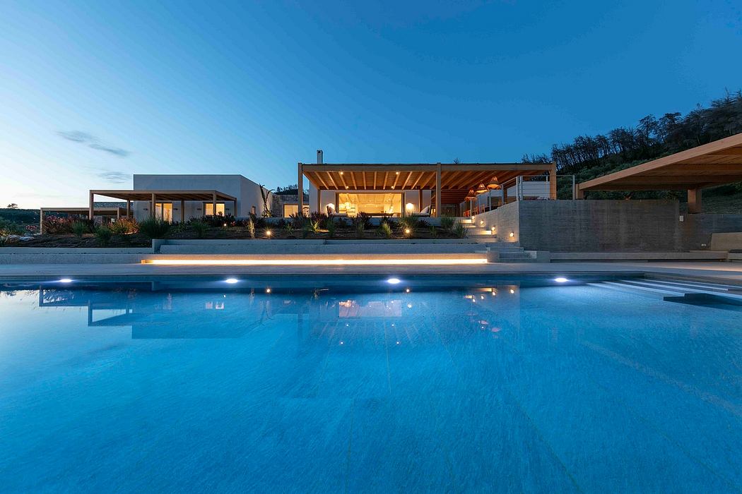 Luxurious villa with modern architectural design, poolside terrace, and landscaped gardens.