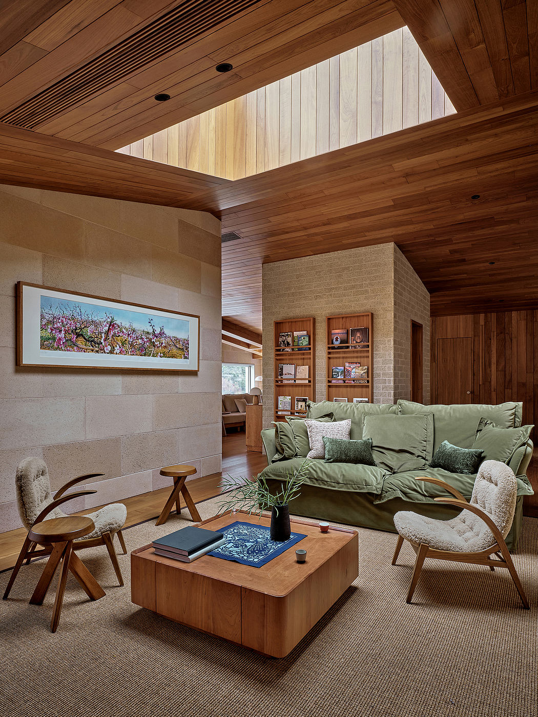 Cozy living room with wooden ceiling, large sofa, and wooden coffee table.