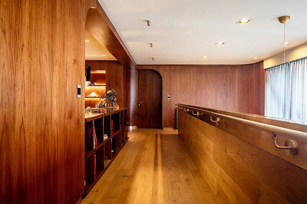A cozy yet modern interior with warm wood paneling, built-in shelving, and recessed lighting.