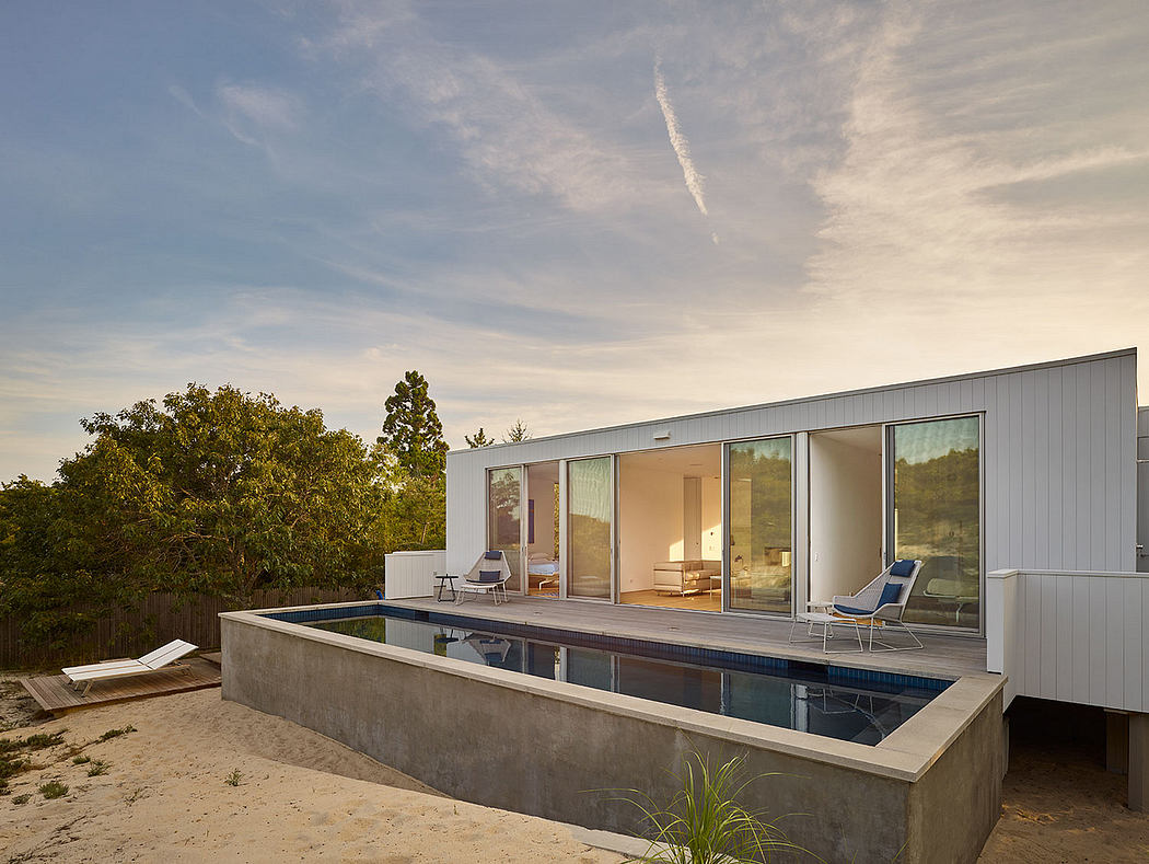 Modern minimalist house with pool, large windows, and deck. Sleek architectural design.