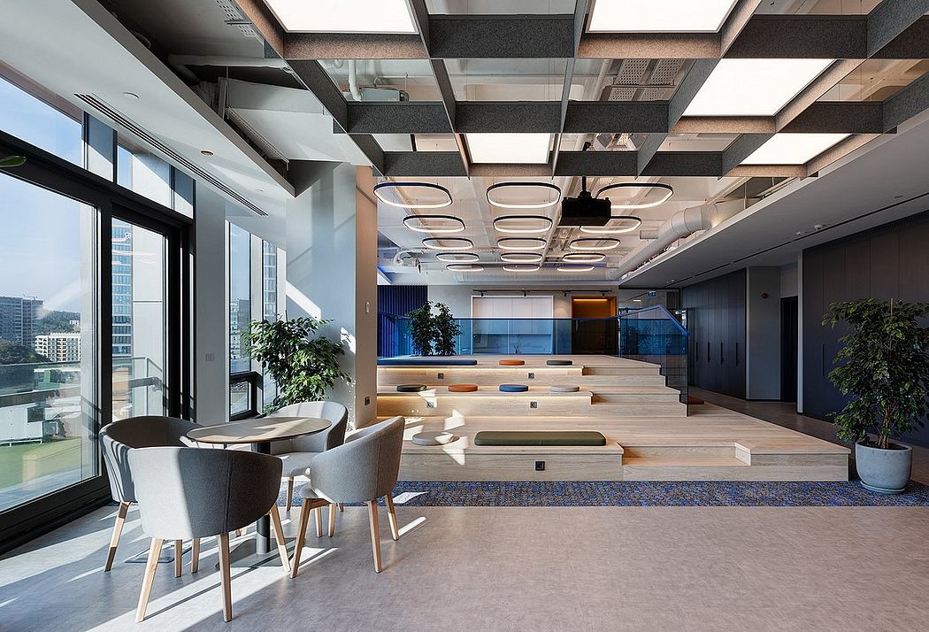 Expansive modern office space with sleek wooden accents, tiered seating, and ample natural light.